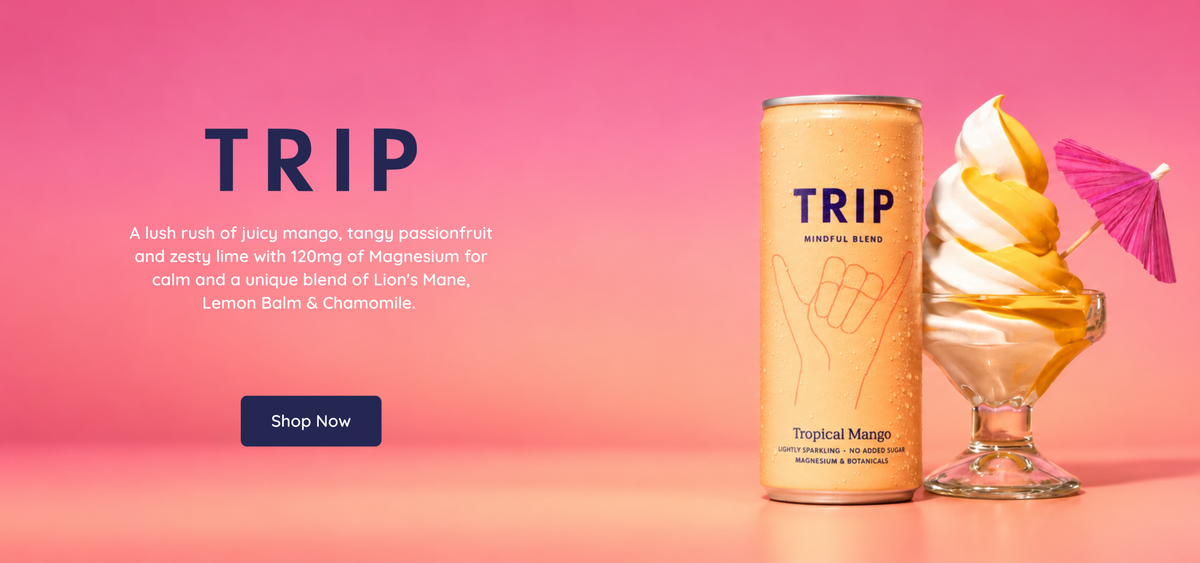 TRIP Tropical Mango Mindful Blend can beside a mango-topped soft serve dessert on a pink background, featuring magnesium and a blend of Lion’s Mane, Lemon Balm and Chamomile.